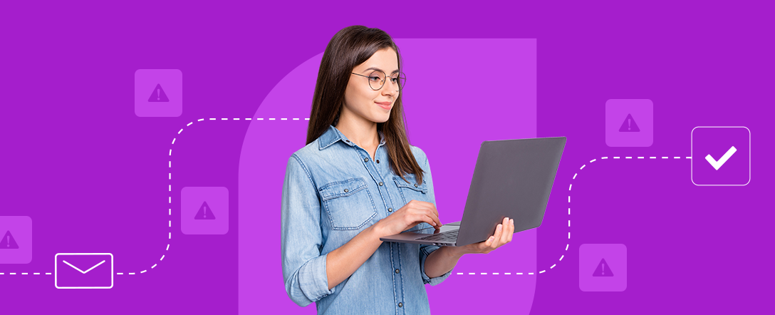 In a purple background, a white woman is holding a laptop and smiling. In the background there are SPAM signs, but her email goes through with a green check sign.